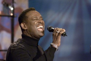 Luther Vandross performing on stage.